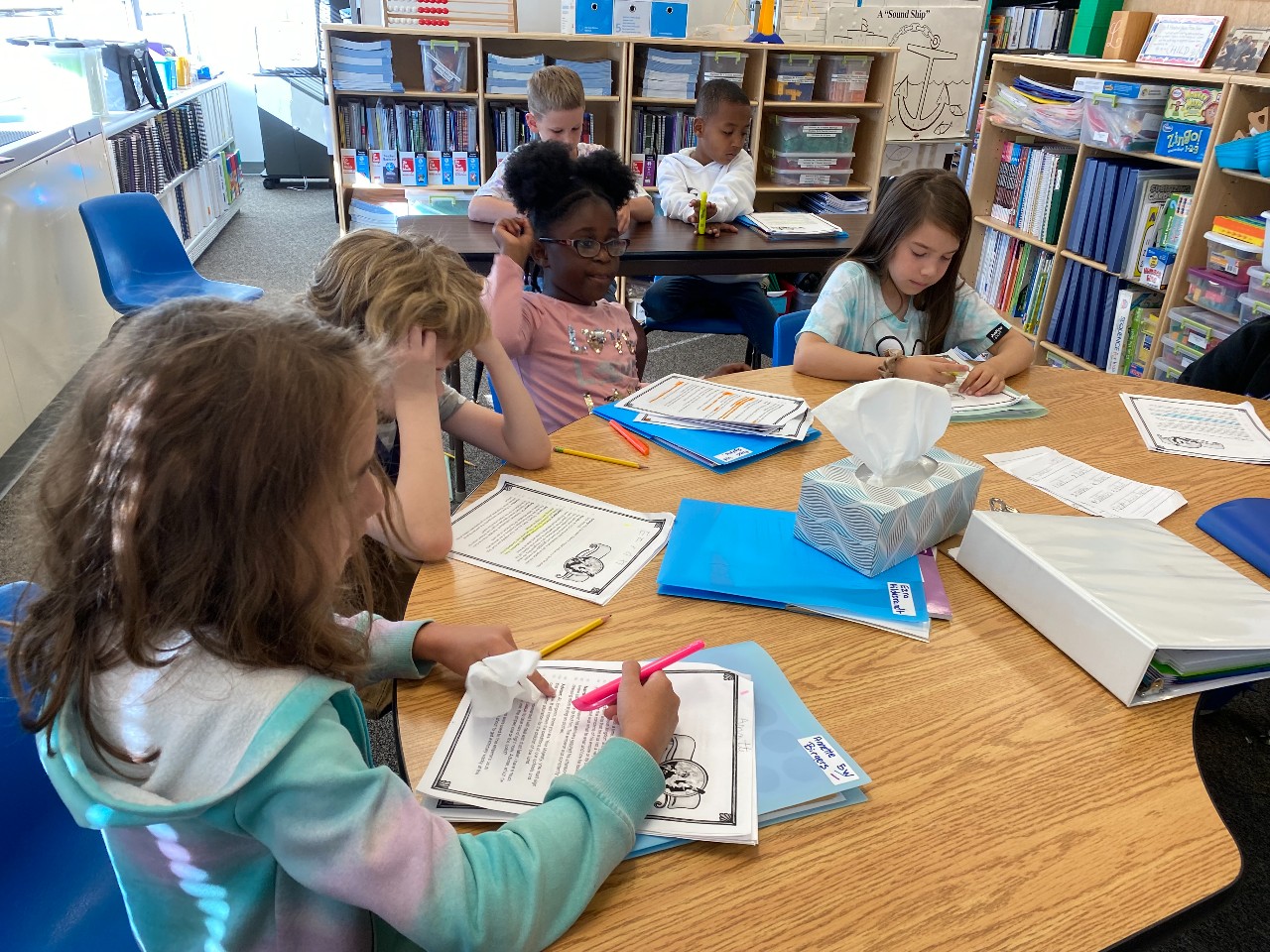 DVES students study at a table in their classroom.